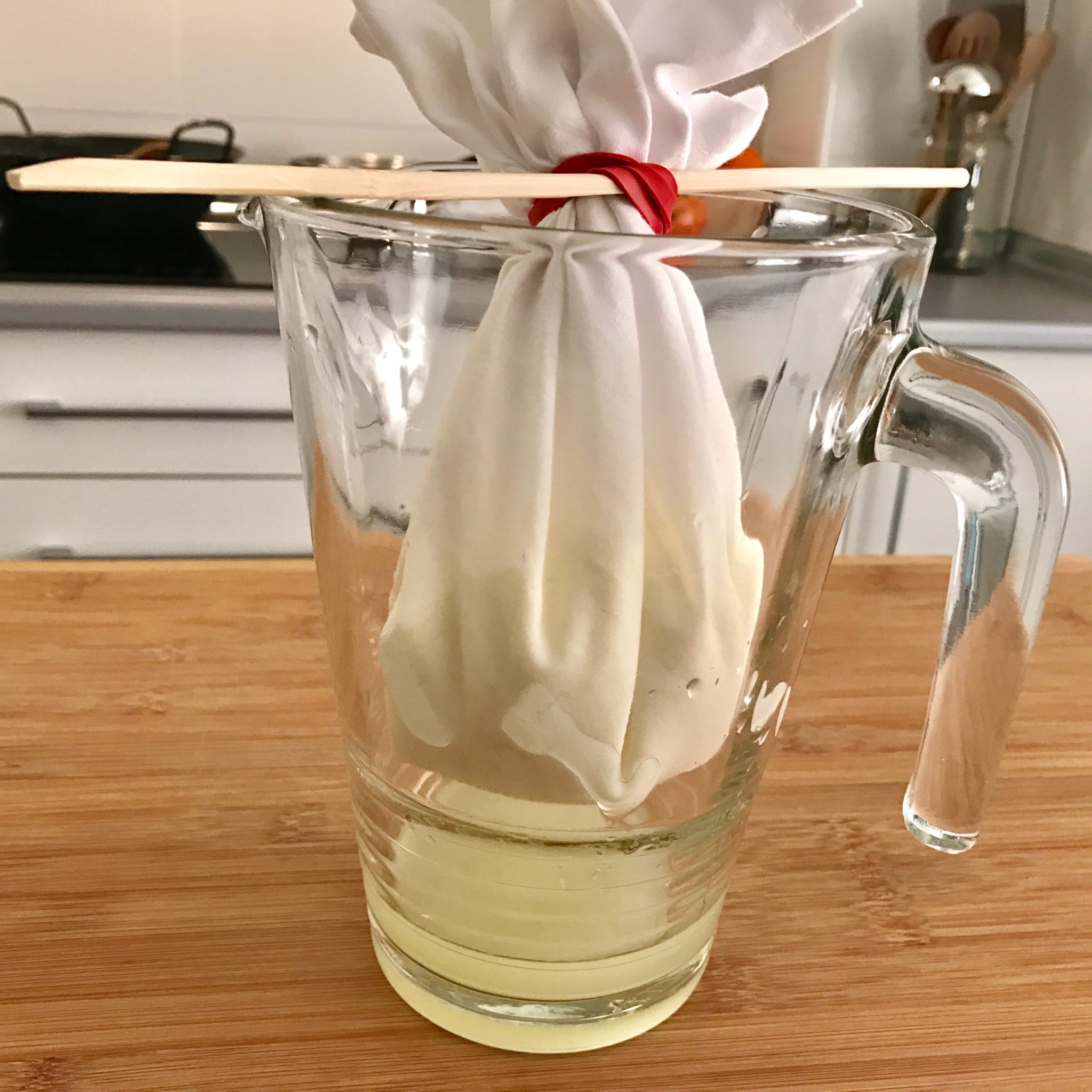 tie the napkin with the rubber band, insert the stick through and hang it on the pitcher