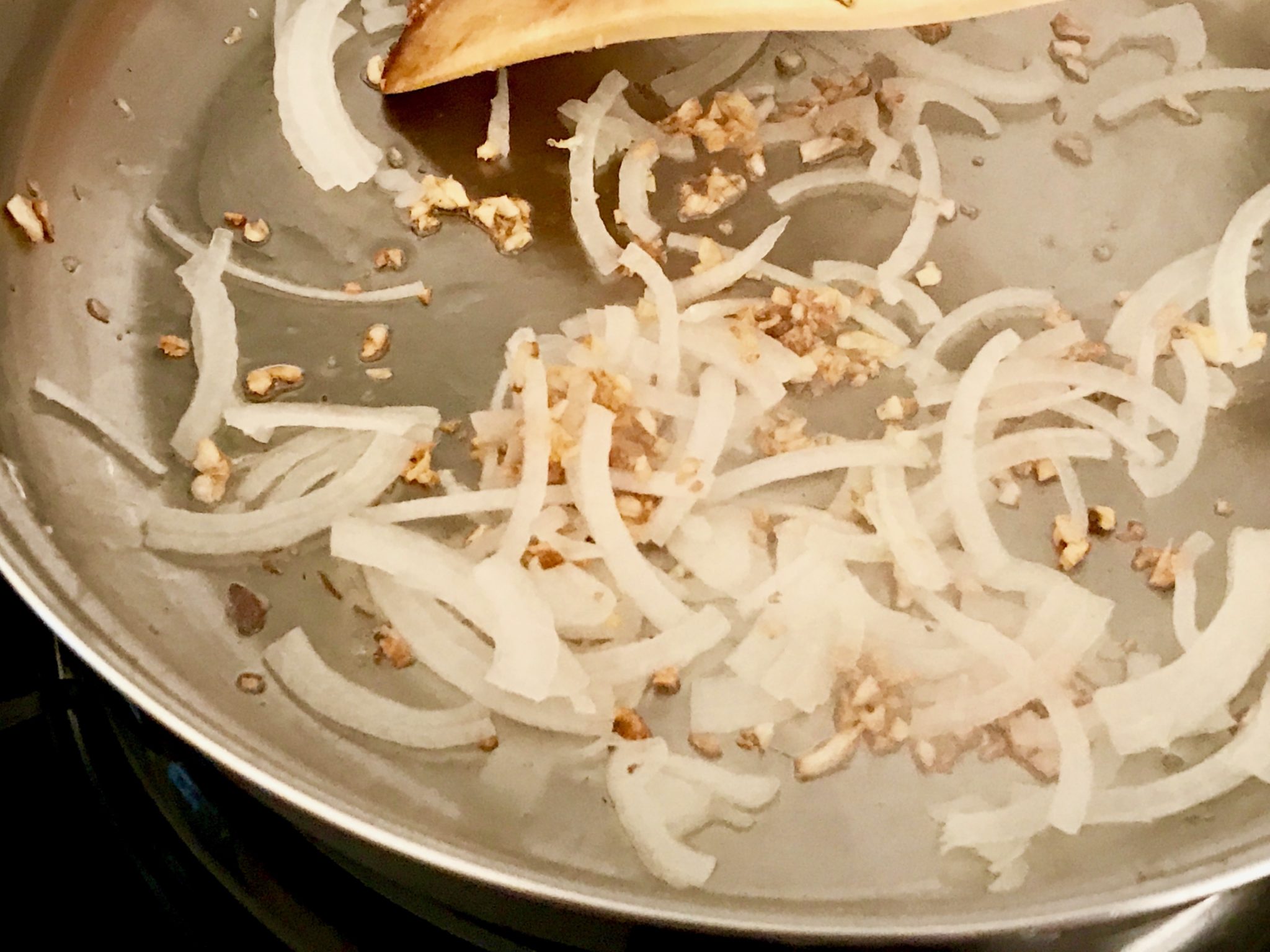 when the garlic looks golden brown, add the onion 