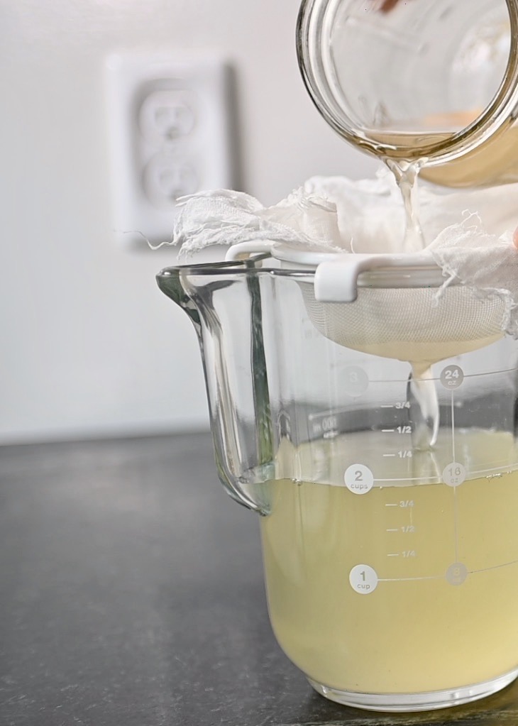 straining the vinegar through cheesecloth