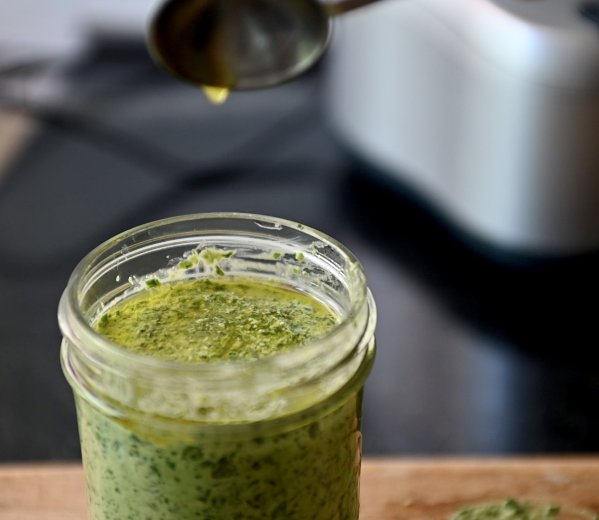 extra virgin olive oil on vegan basil pesto